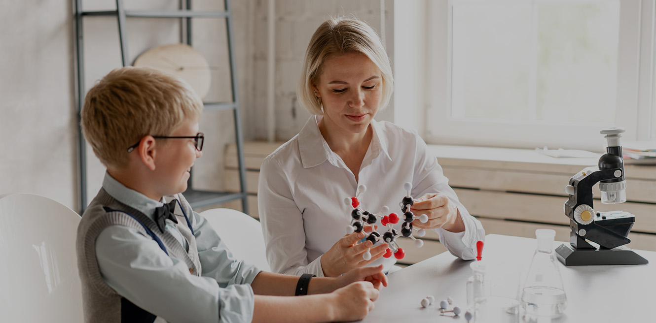 Female science tutor in Manhattan studying chemistry with student